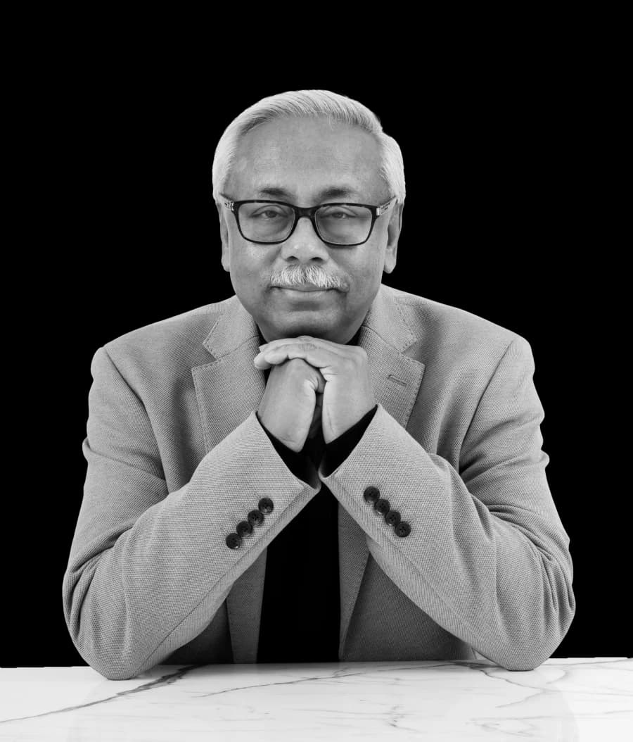 Suvo Sarkar, host of Money Majlis, in a black and white portrait with hands clasped beneath the chin